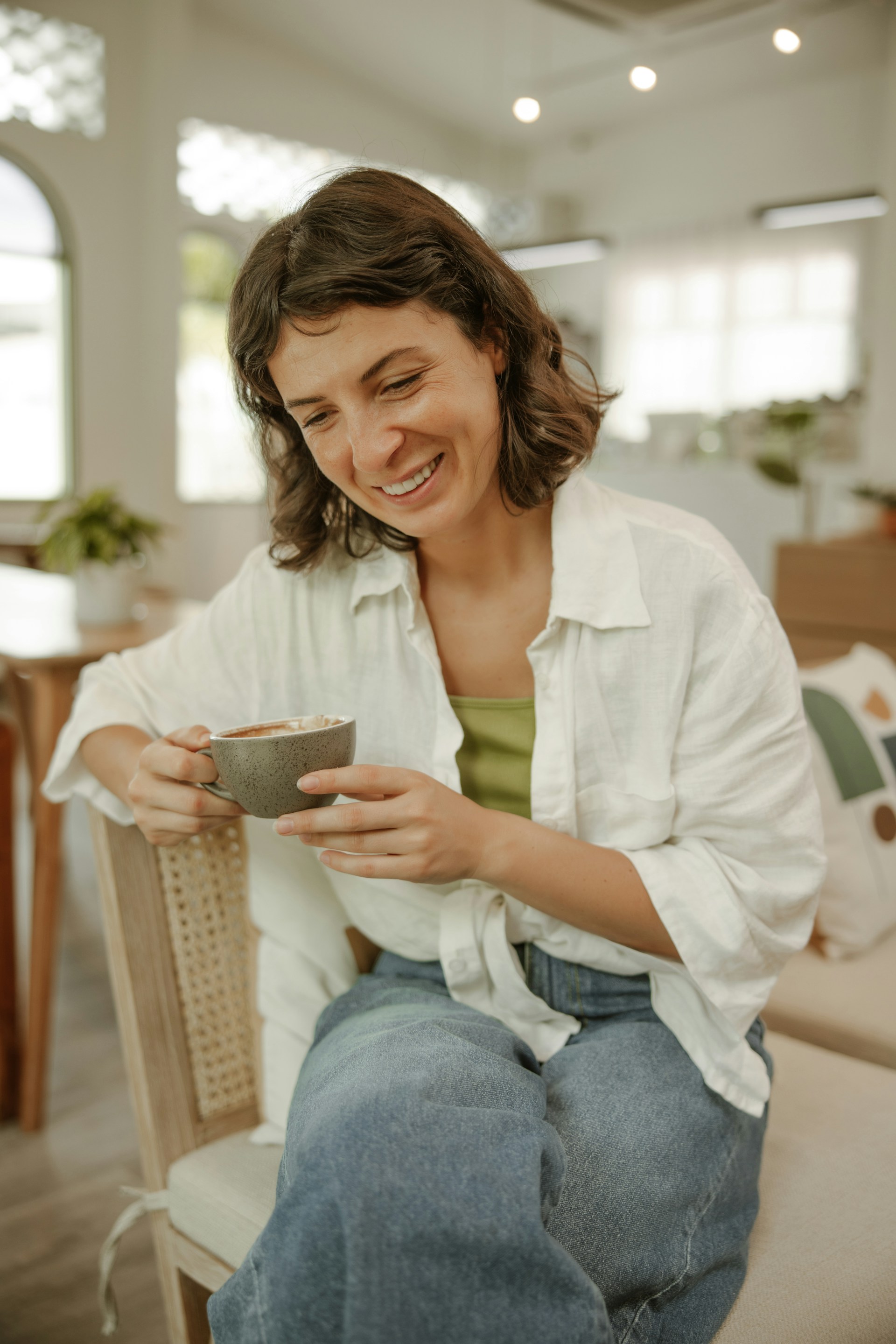 A relieved person smiling while reading a letter